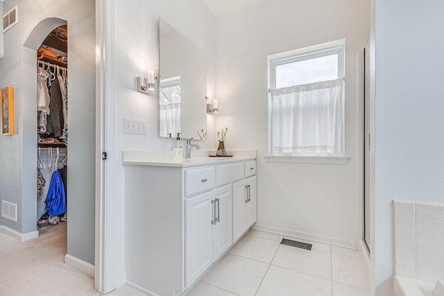 183 Twin Valley Trl, Cedar Grove, WI 53013 - full bathroom featuring visible vents, baseboards, a walk in closet, and vanity