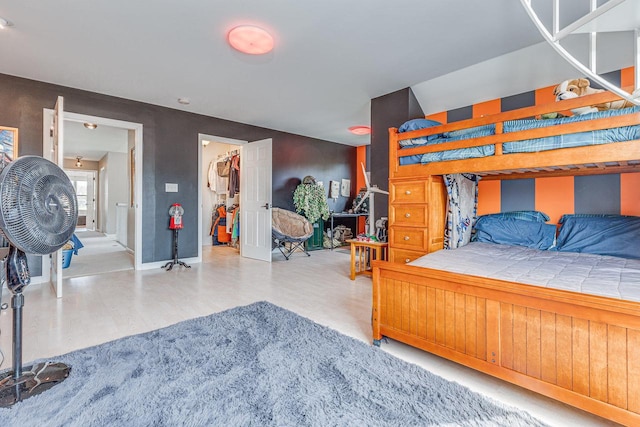 183 Twin Valley Trl, Cedar Grove, WI 53013 - bedroom featuring baseboards, wood finished floors, and a spacious closet