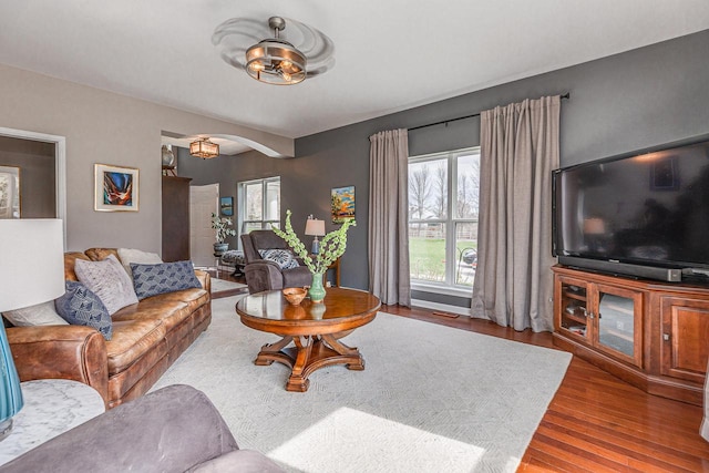 183 Twin Valley Trl, Cedar Grove, WI 53013 - living room with visible vents, arched walkways, and wood finished floors