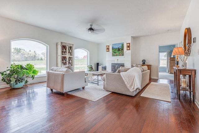 183 Twin Valley Trl, Cedar Grove, WI 53013 - living room featuring dark wood-type flooring, a ceiling fan, and a glass covered fireplace