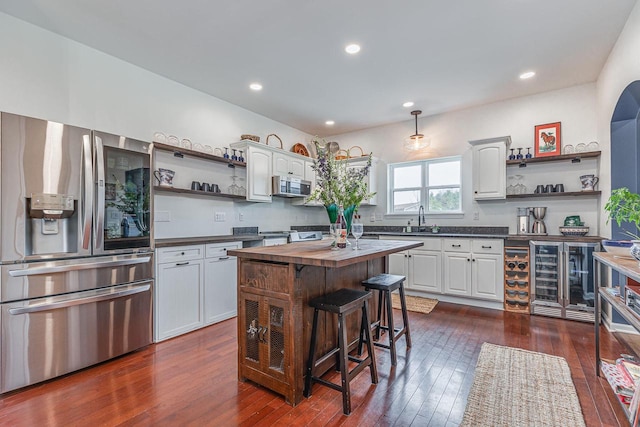 183 Twin Valley Trl, Cedar Grove, WI 53013 - kitchen with appliances with stainless steel finishes, open shelves, beverage cooler, and butcher block counters
