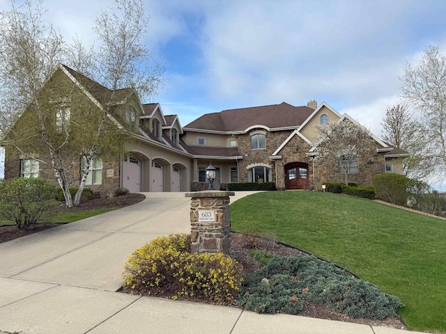 view of front of house with a front lawn, stone siding, a garage, a chimney, and curved driveway