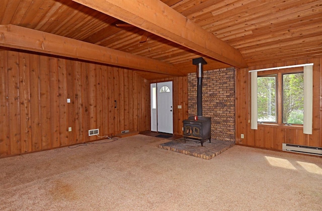 5109 Whitcomb Dr, Madison, WI 53711 - unfurnished living room featuring a wood stove, a baseboard radiator, wooden ceiling, carpet flooring, and wood walls