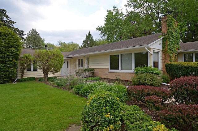 5109 Whitcomb Dr, Madison, WI 53711 - view of side of home with a chimney, a lawn, and roof with shingles