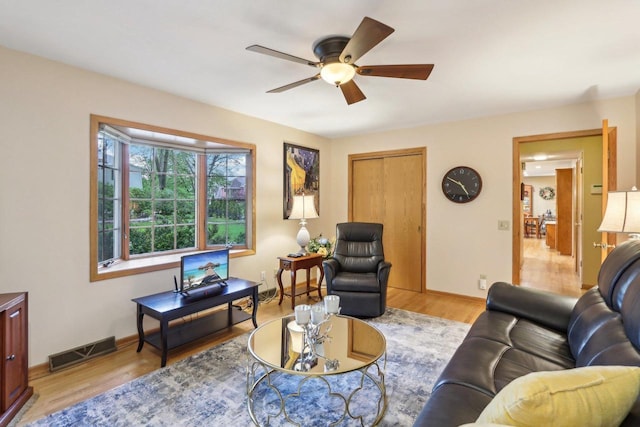 6614 Inner Dr, Madison, WI 53705 - living area with wood finished floors, a ceiling fan, and baseboards