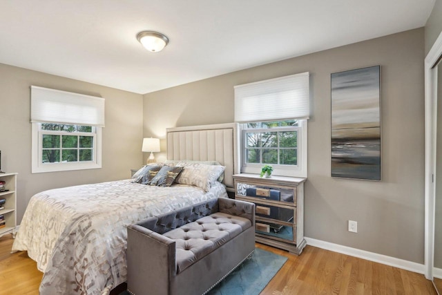 6614 Inner Dr, Madison, WI 53705 - bedroom with multiple windows, wood finished floors, and baseboards