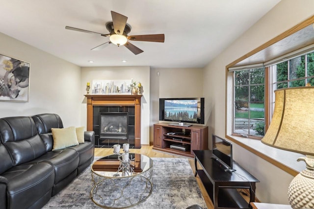 6614 Inner Dr, Madison, WI 53705 - living area featuring a tiled fireplace, a ceiling fan, and wood finished floors