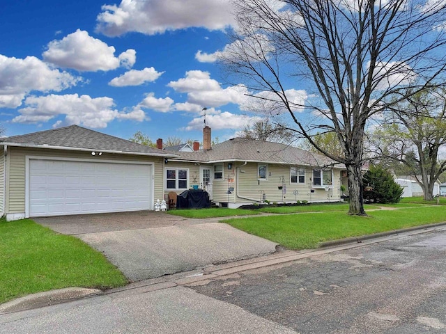 ranch-style house featuring a garage, a front yard, driveway, and a chimney
