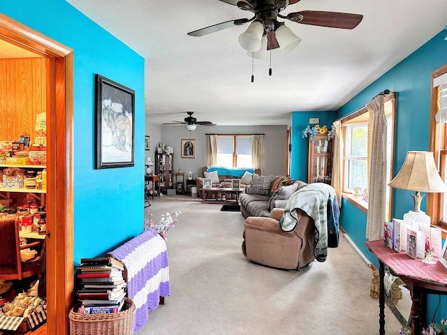 living room with carpet floors and ceiling fan