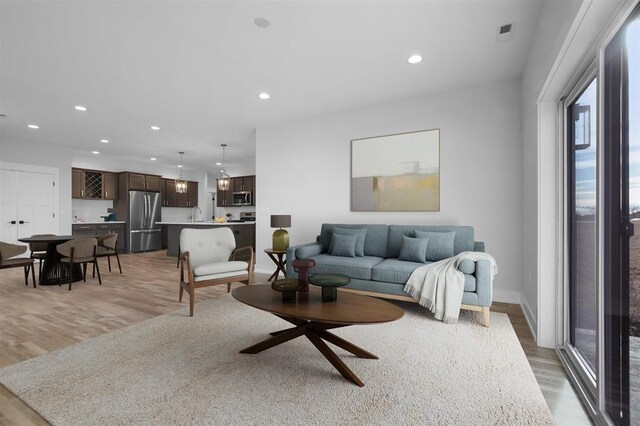 306 NW 3rd St, Monroe, WI 53566 - living room featuring recessed lighting, baseboards, and light wood finished floors