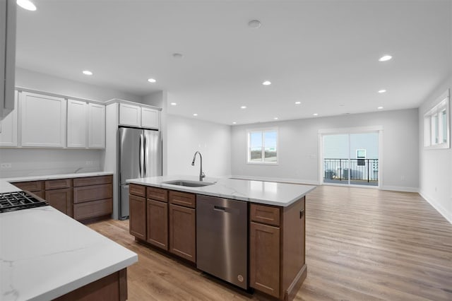 221 NW 3rd Ave, Monroe, WI 53566 - kitchen featuring stainless steel appliances, plenty of natural light, a sink, and light wood-style floors