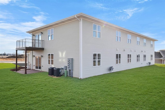 223 NW 3rd Ave, Monroe, WI 53566 - back of house with a balcony, central air condition unit, and a yard