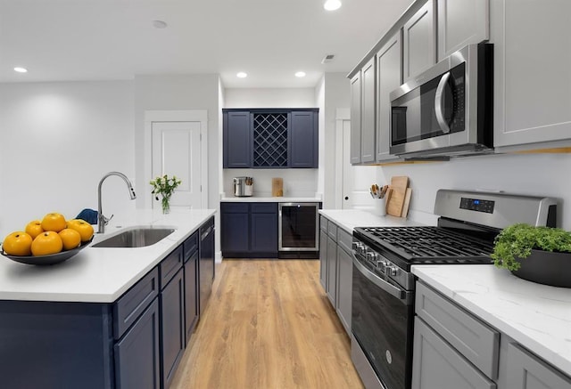 223 NW 3rd Ave, Monroe, WI 53566 - kitchen with a sink, beverage cooler, stainless steel appliances, recessed lighting, and light wood-type flooring