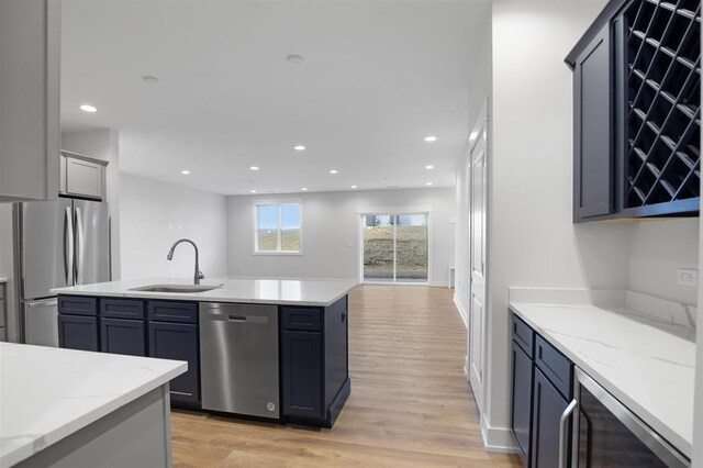 223 NW 3rd Ave, Monroe, WI 53566 - kitchen with wine cooler, a sink, light wood-style floors, stainless steel appliances, and recessed lighting