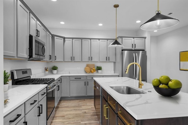 255 NW 3rd Ave, Monroe, WI 53566 - kitchen featuring appliances with stainless steel finishes, a sink, light wood-style floors, recessed lighting, and an island with sink