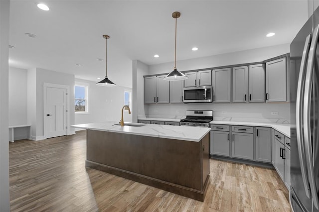255 NW 3rd Ave, Monroe, WI 53566 - kitchen with a sink, gray cabinetry, stainless steel appliances, and light wood-type flooring