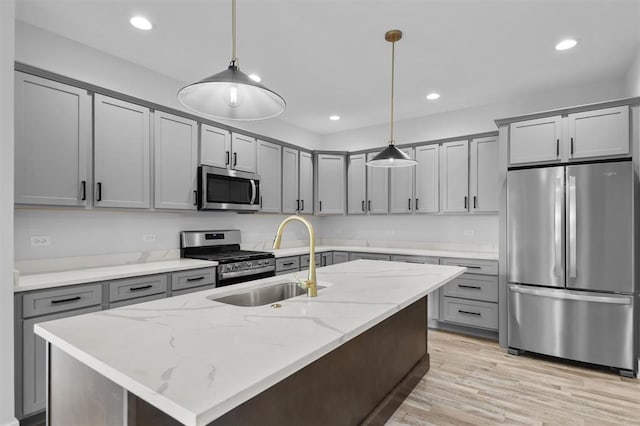 255 NW 3rd Ave, Monroe, WI 53566 - kitchen featuring gray cabinetry, light stone countertops, appliances with stainless steel finishes, and a sink