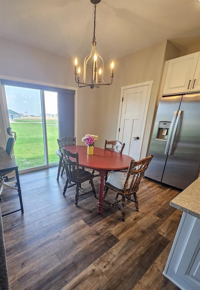 456 N Hyland St, Juneau, WI 53039 - dining area with a chandelier and dark wood finished floors