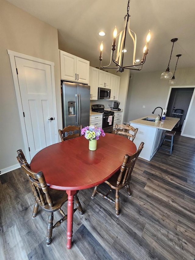 456 N Hyland St, Juneau, WI 53039 - dining area featuring a chandelier, dark wood-style floors, and baseboards