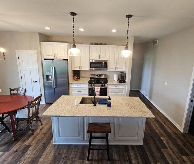 456 N Hyland St, Juneau, WI 53039 - kitchen featuring appliances with stainless steel finishes, baseboards, dark wood-style flooring, white cabinetry, and recessed lighting