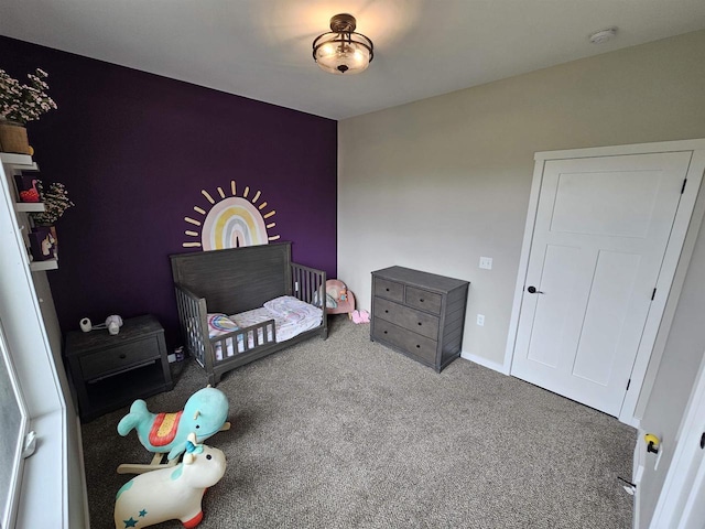 456 N Hyland St, Juneau, WI 53039 - carpeted bedroom featuring a crib and baseboards