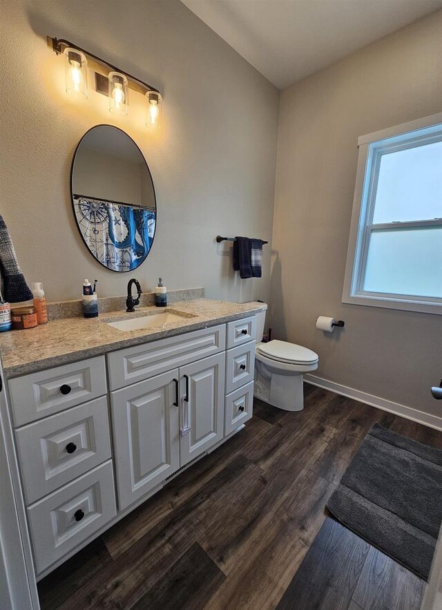 456 N Hyland St, Juneau, WI 53039 - bathroom with vanity, toilet, and wood finished floors