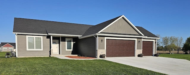 456 N Hyland St, Juneau, WI 53039 - view of front of home featuring an attached garage, driveway, a front lawn, and board and batten siding