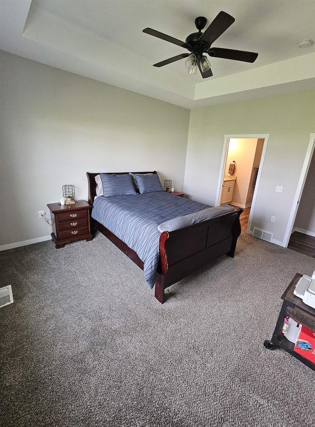 456 N Hyland St, Juneau, WI 53039 - carpeted bedroom featuring a raised ceiling, baseboards, and ceiling fan
