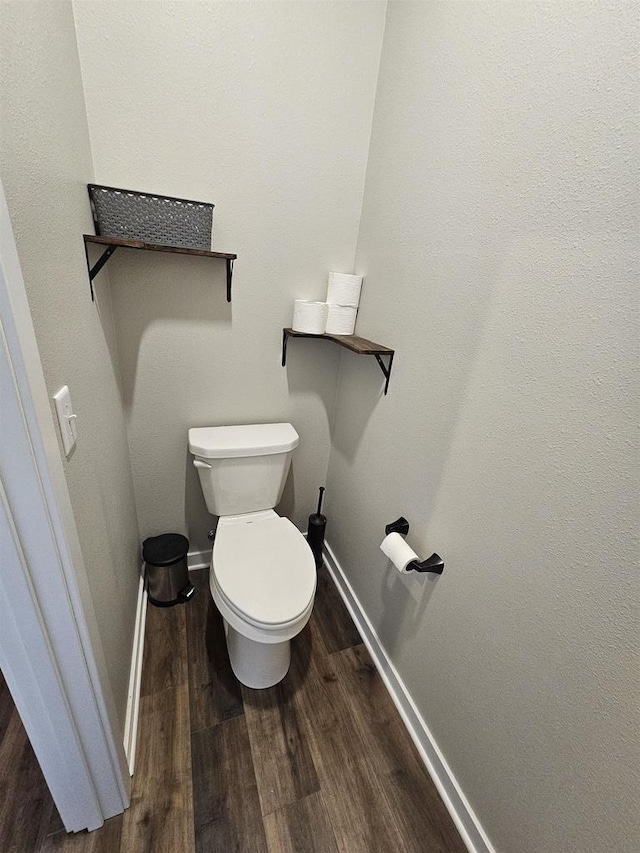 456 N Hyland St, Juneau, WI 53039 - bathroom featuring wood finished floors, baseboards, and toilet