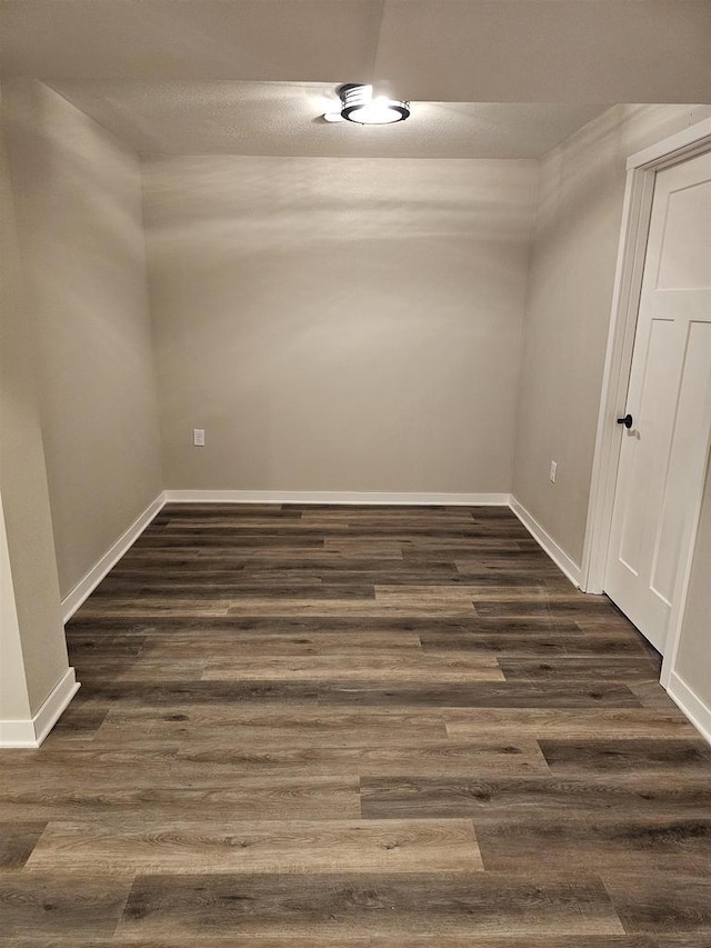 456 N Hyland St, Juneau, WI 53039 - spare room featuring dark wood-style flooring and baseboards