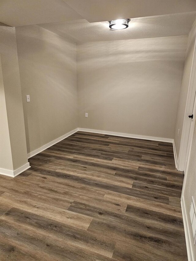456 N Hyland St, Juneau, WI 53039 - empty room featuring dark wood finished floors and baseboards