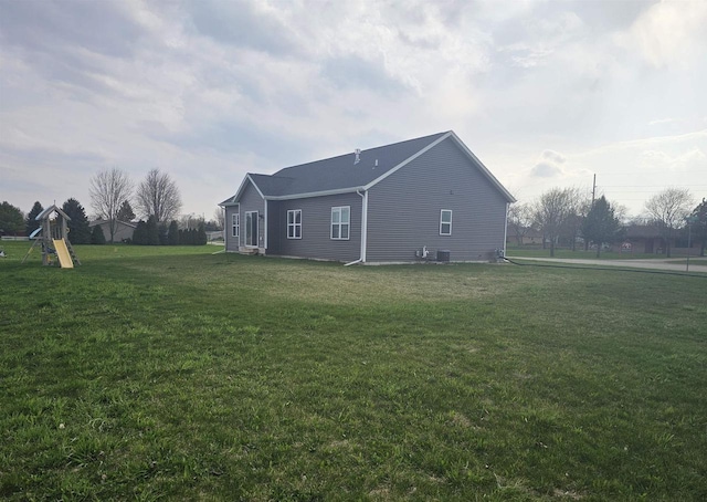 456 N Hyland St, Juneau, WI 53039 - view of side of home with a yard and cooling unit