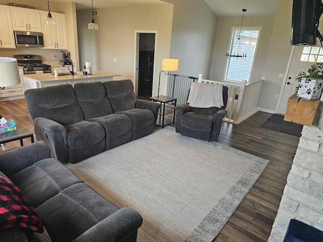 456 N Hyland St, Juneau, WI 53039 - living room with dark wood finished floors, a chandelier, and baseboards