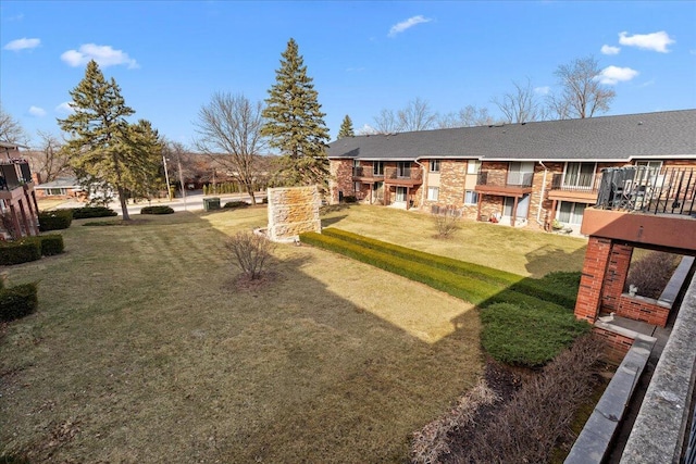 N84W16033 Menomonee Ave Unit 200, Menomonee Falls, WI 53051 - view of grassy yard with a balcony