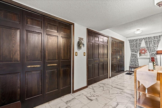 N84W16033 Menomonee Ave Unit 200, Menomonee Falls, WI 53051 - foyer entrance with light marble finish flooring and a textured ceiling