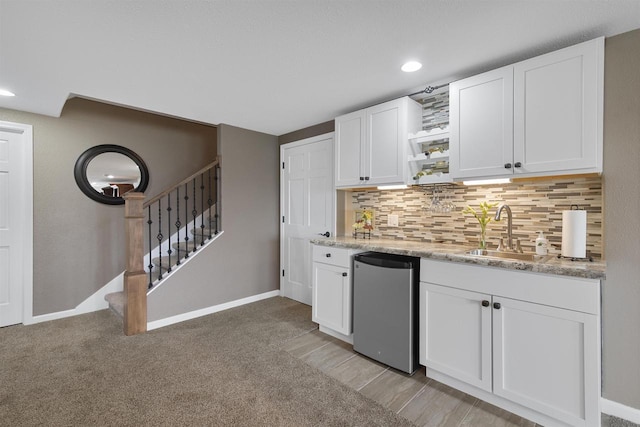 kitchen featuring fridge, a sink, open shelves, decorative backsplash, and white cabinets