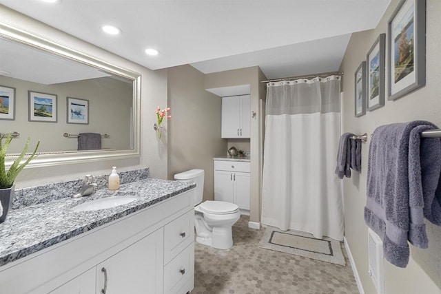 bathroom with toilet, a shower with shower curtain, vanity, and recessed lighting