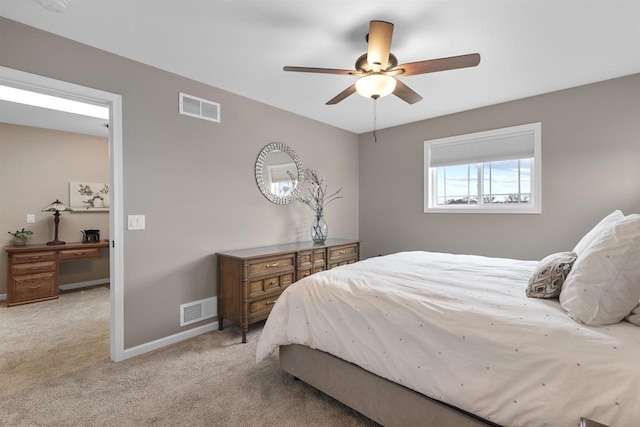 bedroom with visible vents, baseboards, a ceiling fan, and light carpet