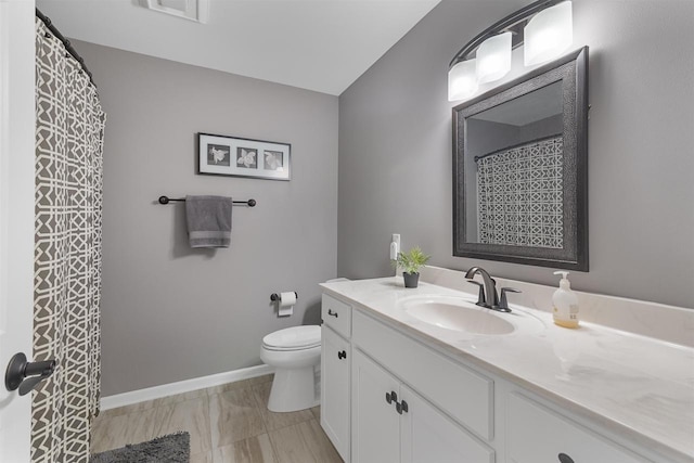 bathroom featuring toilet, visible vents, baseboards, and vanity