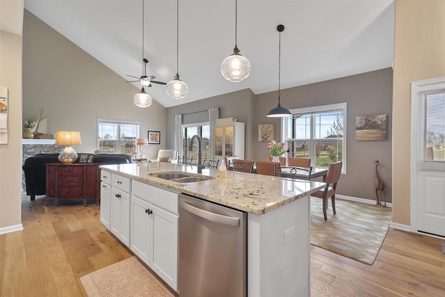 kitchen with dishwasher, a healthy amount of sunlight, light wood finished floors, a sink, and white cabinets