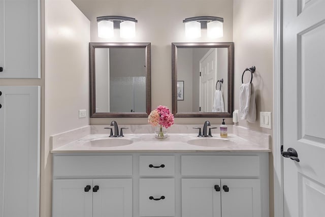 full bathroom with double vanity and a sink