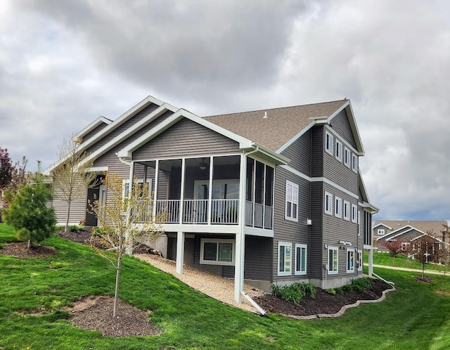 back of house with a lawn and a sunroom