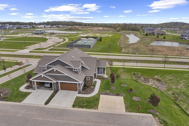 bird's eye view featuring a water view and a residential view