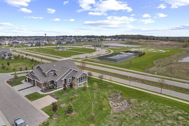 drone / aerial view with a water view and a residential view