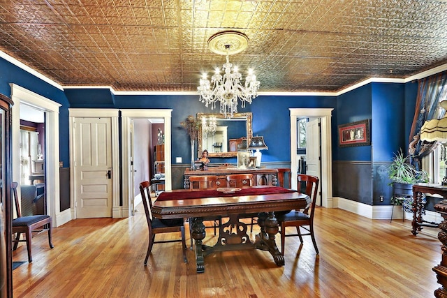 N1453 Clover Rd, Genoa City, WI 53128 - dining room featuring crown molding, an ornate ceiling, a chandelier, and wood finished floors