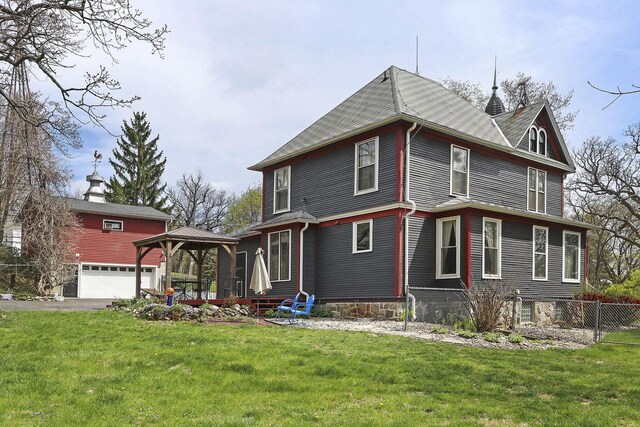 N1453 Clover Rd, Genoa City, WI 53128 - view of front facade featuring a gazebo, a garage, fence, and a front yard