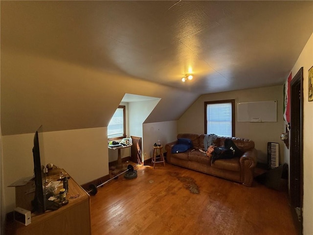 bonus room with vaulted ceiling and wood finished floors
