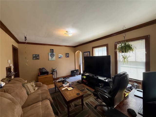 living area featuring arched walkways and ornamental molding
