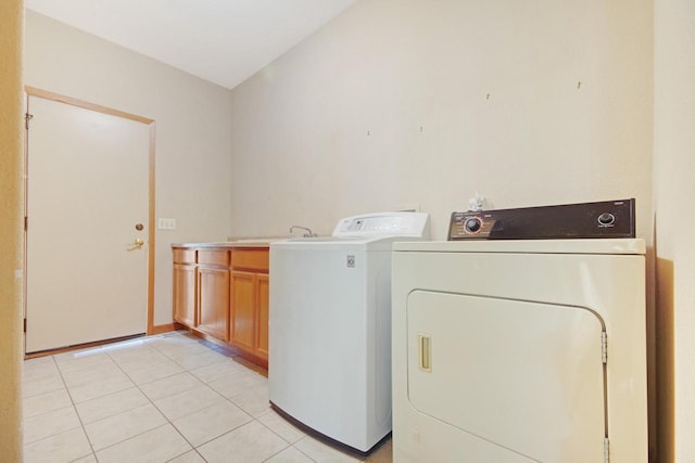 524 Tindalls Nest, Twin Lakes, WI 53181 - clothes washing area with cabinet space, light tile patterned floors, and washing machine and clothes dryer