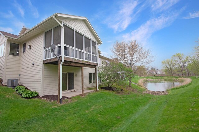 524 Tindalls Nest, Twin Lakes, WI 53181 - rear view of property featuring a lawn, a patio area, a sunroom, central AC, and a water view